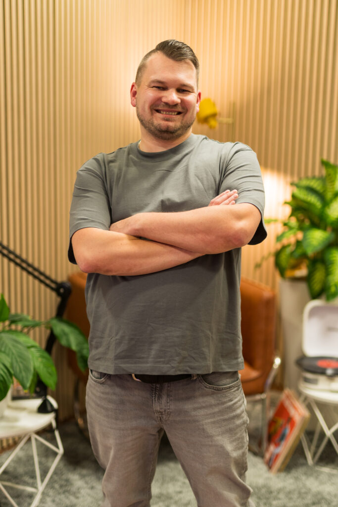 Porträt von Hochzeits DJ Tomasz von der Doojayschmiede vor Holzhintergrund